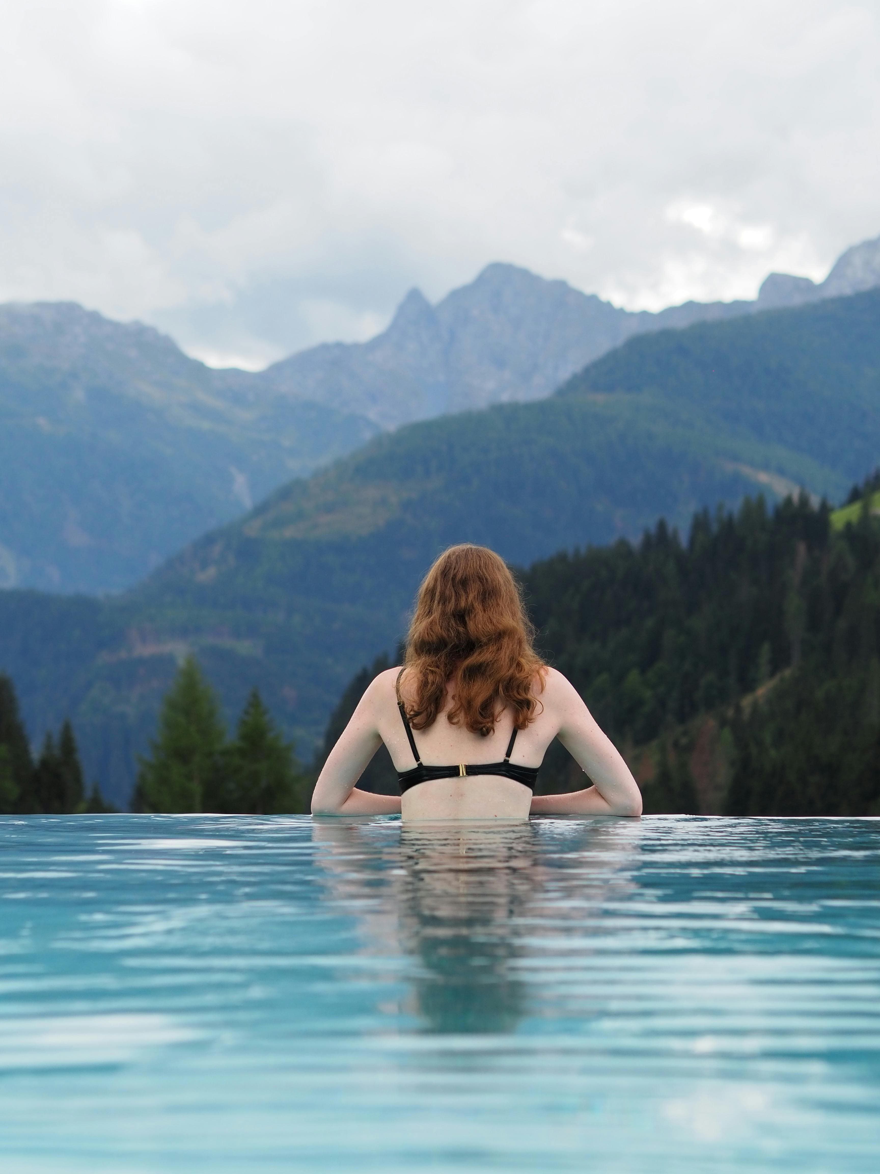Backyard swimming pool with bright blue water and patio
