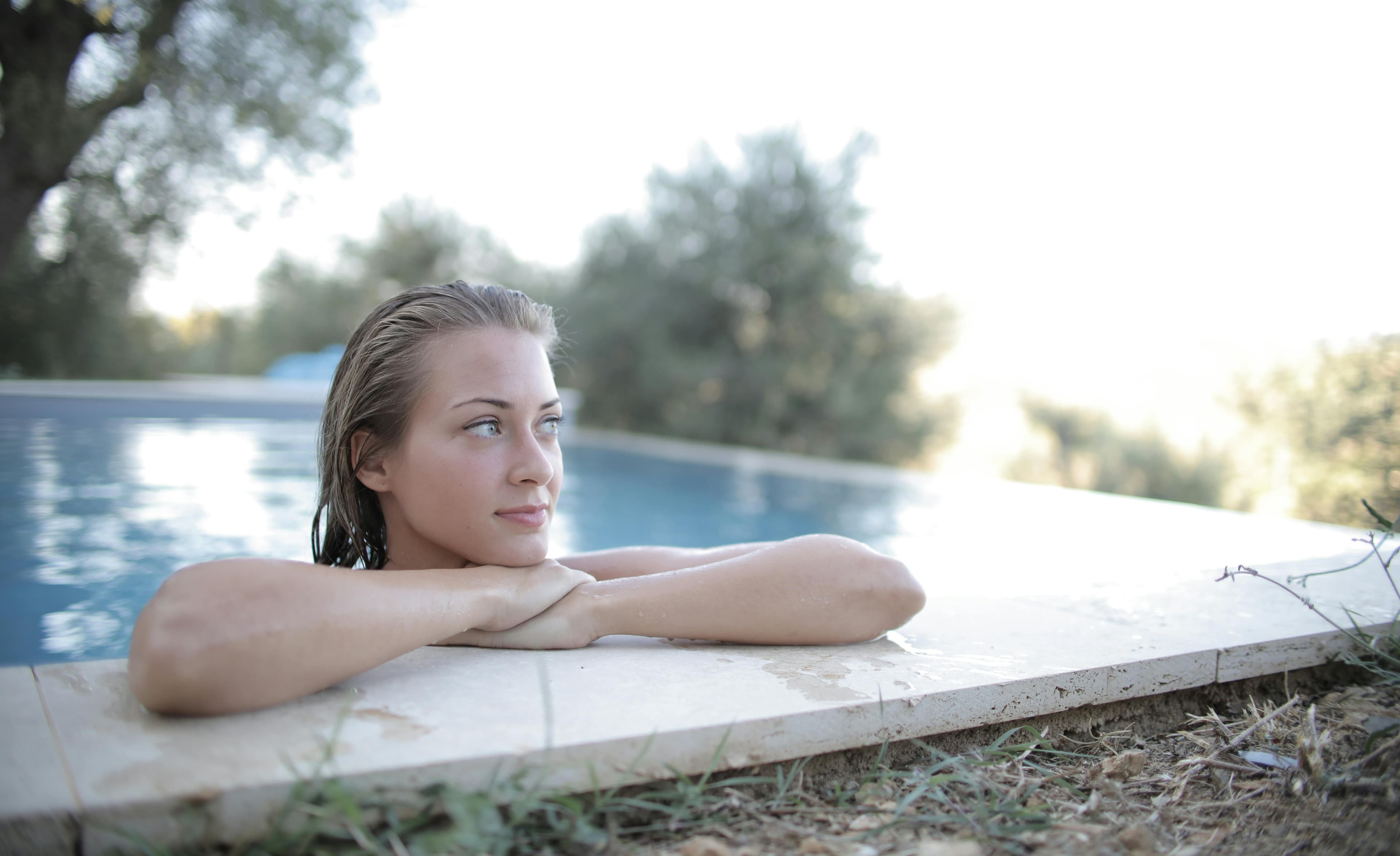 Poolside lounge area with palms on a sunny day